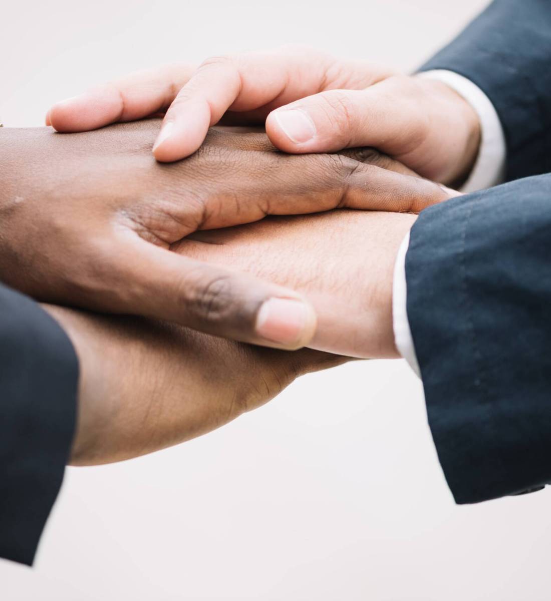 colleagues-holding-hands-together-min